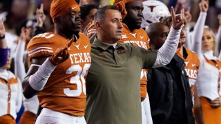 Texas coach Steve Sarkisian, center, stands with linebacker Devin Richardson