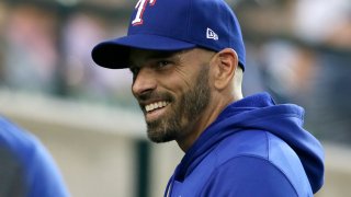 Texas Rangers manager Chris Woodward smiles before a baseball game