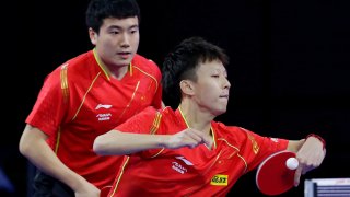 China's Liang Jingkun, left, looks on as Lin Gaoyuan, right, returns a volley during a men's doubles match on the fourth day of the 2021 World Table Tennis Championships Friday, Nov. 26, 2021, in Houston.