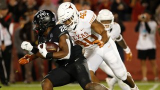 Running back Breece Hall #28 of the Iowa State Cyclones is tackled by linebacker Ayodele Adeoye #40 of the Texas Longhorns as he rushed for yards in the first half of play at Jack Trice Stadium on Nov. 6, 2021 in Ames, Iowa.