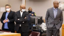 Billy Chemirmir, center, with his defense team, Nov. 19, 2021.