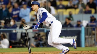 Corey Seager #5 of the Los Angeles Dodgers singles in the eighth inning during Game 5 of the NLCS between the Atlanta Braves and the Los Angeles Dodgers at Dodgers Stadium on Thursday, Oct. 21, 2021 in Los Angeles, California.