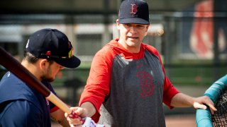 Hitting coach Tim Hyers works with Michael Chavis #23 of the Boston Red Sox during a team workout on February 12, 2020 at JetBlue Park at Fenway South in Fort Myers, Florida.