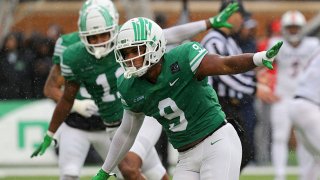 Grayson Murphy #9 and Gabriel Murphy #11 of the North Texas Mean Green celebrate after sacking quarterback Josh Adkins #8 of the UTSA Roadrunners in the third quarter at Apogee Stadium on Nov. 27, 2021 in Denton, Texas.