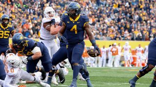 West Virginia Mountaineers running back Leddie Brown (4) crosses ht goal line for a touchdown during a game between the West Virginia University Mountaineers and the Texas Longhorns on Nov. 20, 2021 at Mountaineer Field at Milan Puskar Stadium in Morgantown, West Virginia.