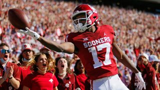 Wide receiver Marvin Mims #17 of the Oklahoma Sooners rolls the ball off his fingertips after scoring on a 67-yard catch and run against the Texas Tech Red Raiders in the first quarter at Gaylord Family Oklahoma Memorial Stadium on Oct. 30, 2021 in Norman, Oklahoma.