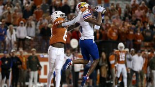 O.J. Burroughs #5 of the Kansas Jayhawks intercepts a pass intended for Xavier Worthy #8 of the Texas Longhorns in the end zone in the fourth quarter at Darrell K Royal-Texas Memorial Stadium on Nov. 13, 2021 in Austin, Texas.