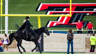 The Masked Rider rides Fearless Champion across the field during the first half of the college football game between Texas Tech Red Raiders and the TCU Horned Frogs at Jones AT&T Stadium on Oct. 9, 2021 in Lubbock, Texas.