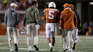 Bijan Robinson #5 of the Texas Longhorns walks to the locker room with members of the medical team in the third quarter against the Kansas Jayhawks at Darrell K Royal-Texas Memorial Stadium on Nov. 13, 2021 in Austin, Texas.