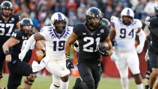 Running back Breece Hall #28 of the Iowa State Cyclones drives the ball down field for a touchdown as linebacker Shadrach Banks #19, and defensive tackle Corey Bethley #94 of the TCU Horned Frogs defend in the first half of play at Jack Trice Stadium on Nov. 26, 2021 in Ames, Iowa.