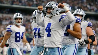 Dak Prescott #4 of the Dallas Cowboys celebrates his rushing touchdown against the Atlanta Falcons during the third quarter at AT&T Stadium on Nov. 14, 2021 in Arlington, Texas.