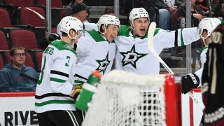 Roope Hintz #24 of the Dallas Stars celebrates with John Klingberg #3, Jason Robertson #21 and Joe Pavelski #16 after scoring a goal against the Arizona Coyotes during the first period at Gila River Arena on Nov. 27, 2021 in Glendale, Arizona.