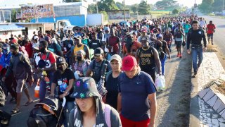 Migrants walk along a road in a caravan heading to the U.S. border, in Tapachula, Mexico November 18, 2021.