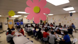 Migrant teens eat lunch at a "tender-age" facility