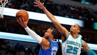 Dallas Mavericks guard Jalen Brunson (13) goes up to shoot against Charlotte Hornets forward P.J. Washington (25) in the first half of an NBA basketball game Monday, Dec. 13, 2021, in Dallas.