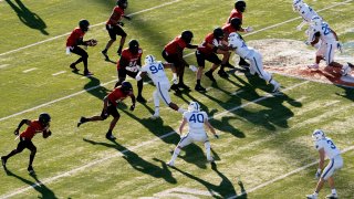 Louisville quarterback Malik Cunningham (3) takes the snap during the first half of the First Responder Bowl NCAA college football game against Air Force Tuesday, Dec. 28, 2021, in Dallas. (AP Photo/Jeffrey McWhorter)