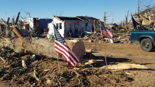 Marty James, left, 59, and a neighbor stand in front of his house in Mayfield, Kentucky, on Dec. 12, 2021 after it was destroyed by a tornado.