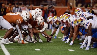 Players from the Kansas Jayhawks and the Texas Longhorns line up for a play during Big XII game between the Kansas Jayhawks and the Texas Longhorns on Nov. 13, 2021 at Darrell K Royal-Texas Memorial Stadium in Austin, Texas.