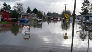 Floodwaters cover a residential street near Centralia, Wash