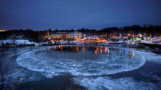 A large ice disk slowly rotates in the Presumpscot River in Westbrook, Maine, Jan. 13, 2022.