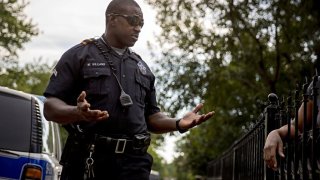 Senior Cpl. Melvin Williams of the Dallas Police Department talked with a woman after answering a call in 2016 in the Pleasant Grove area of Dallas.