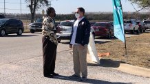 Dallas County Dist. 3 Commissioner John Wiley Price (l) and Dallas County Judge Clay Jenkins (r) talking at the Ellis Davis Field House COVID-19 testing site.