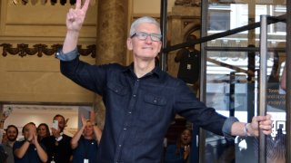 Apple CEO Tim Cook greets customers at the new Apple Store on Broadway in downtown Los Angeles, California, U.S., June 24, 2021.