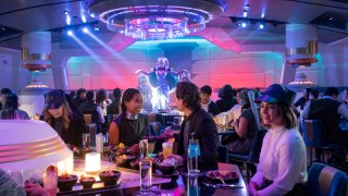 Guests dine in the Crown of Corellia Dining Room during a performance by galactic superstar Gaya.