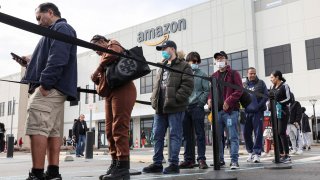 Workers stand in line to cast ballots for a union election at Amazon’s JFK8 distribution center, in the Staten Island borough of New York City, U.S. March 25, 2022.