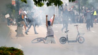 File — Tear gas fills the air after Denver Police fired canisters during a protest outside the State Capitol over the death of George Floyd, in this file photograph taken on Saturday, May 30, 2020, in Denver. A civil lawsuit accusing the Denver Police Department of using indiscriminate force against people protesting the killing of George Floyd is set to go on trial Monday, March 7, 2022, in federal court.