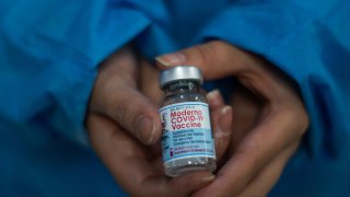 A nurse shows the vial of the Moderna novel Coronavirus vaccine as public transport drivers and people from ages 25 to 30 start their vaccination phase with the Moderna novel COVID-19 vaccine against the Coronavirus disease in Bogota, Colombia on August 2, 2021. (Photo by:Ximena Rubio/Long Visual Press/Universal Images Group via Getty Images)