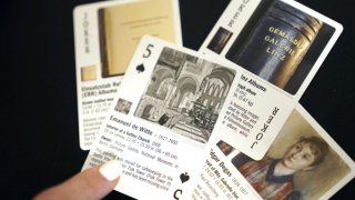 Anna Bottinelli, president of the Monuments Men Foundation for the Preservation of Art, displays playing cards at the organization’s office in Dallas on Monday. The Dallas-based foundation this week announced that it has created a deck of playing cards featuring missing works of art from World War II.