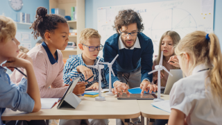 teacher and kids working on STEM project