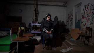 Valentina Saroyan sits in the basement of a school in Yahidne, near Chernihiv, Ukraine, Tuesday, April 12, 2022.