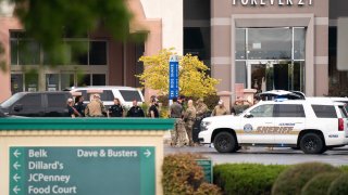 Members of law enforcement gather outside Columbiana Centre mall in Columbia, S.C., following a shooting, Saturday, April 16, 2022.