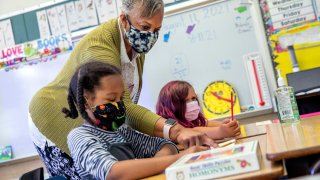 FILE — Joy Harrison instructs her second graders at Carl B. Munck Elementary School, in Oakland, Calif,, Aug. 11, 2021. Oakland is closing seven schools.