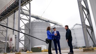 President Joe Biden and Rep. Cindy Axne, D-Iowa, talk with Jack Mitchell, regional vice president of POET Bioprocessing, right, as he gives them a tour at POET Bioprocessing in Menlo, Iowa, Tuesday, April 12, 2022.