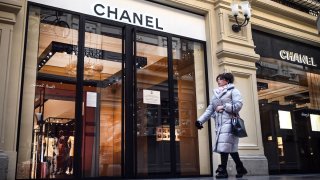 A woman walks past a closed Chanel shop in Moscow on March 10, 2022.