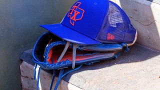 A Texas Rangers hat sits on the dugout step during the MLB Spring Training baseball game between the Arizona Diamondbacks and the Texas Rangers on March 27, 2022 at Surprise Stadium in Surprise, AZ