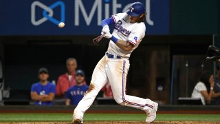 Jonah Heim #28 of the Texas Rangers singles against the Los Angeles Angels during the fifth inning at Globe Life Field on April 14, 2022 in Arlington, Texas.