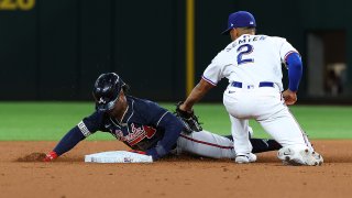 Ozzie Albies #1 of the Atlanta Braves steals second as Marcus Semien #2 of the Texas Rangers is late with the tag in the first inning at Globe Life Field on April 29, 2022 in Arlington, Texas.
