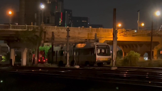 According to a DART spokesman, a car was speeding down South Houston Street when it launched over the bridge wall and into trees next to the train tracks below at about 12:30 a.m.