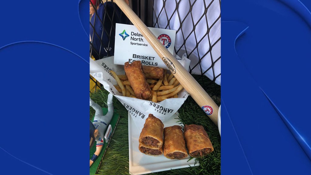 Brisket Egg Rolls: Created by a Rangers fan in 2020 as part of a recipe competition.  Tender house-smoked beef brisket, shredded and wrapped in a classic egg roll with Napa cabbage - deep-fried until crispy and delicious.  Served with Togarashi Seasoned Fries and Sweet Baby Ray's BBQ Sauce for dipping.  Available at the Go Deep Fried stalls in sections 121, 225 and 230.