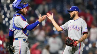 Texas Rangers pitcher Joe Barlow, right, and catcher Jonah Heim celebrate after the Rangers won a baseball game against the Philadelphia Phillies, May 4, 2022, in Philadelphia.