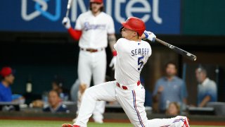 Corey Seager #5 of the Texas Rangers hits a home run in the third inning against the Kansas City Royals at Globe Life Field on May 10, 2022 in Arlington, Texas.