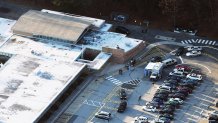 People gather at the scene of a mass school shooting at Sandy Hook Elementary School