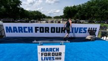 Workers set up for the March for Our Lives rally on the National Mall, near the White House, in Washington, Friday, June 10, 2022.