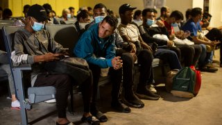 migrants waiting in a terminal