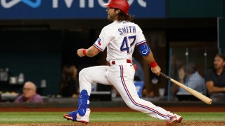 Josh Smith #47 of the Texas Rangers singles during the third inning against the Philadelphia Phillies at Globe Life Field on June 21, 2022 in Arlington, Texas.