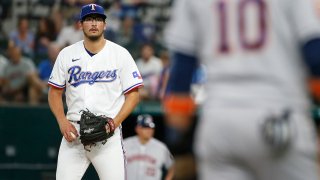 Dane Dunning #33 of the Texas Rangers eyes Yuli Gurriel #10 of the Houston Astros at third base in the second inning at Globe Life Field on June 14, 2022 in Arlington, Texas.